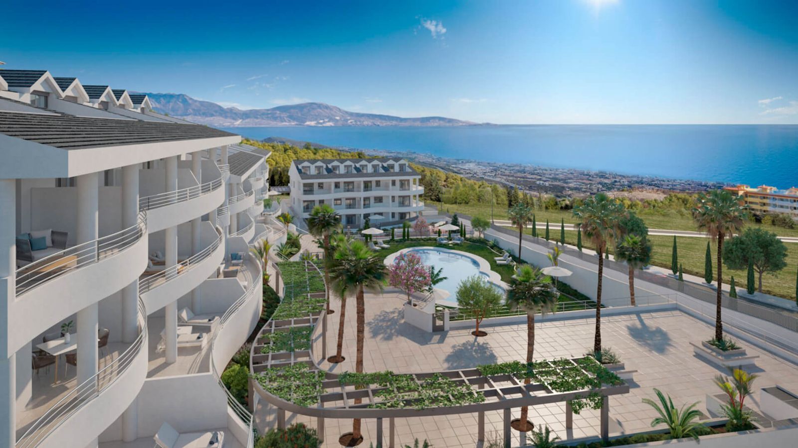 Luftaufnahme von Nexus Residences mit Pool und Küstenblick.